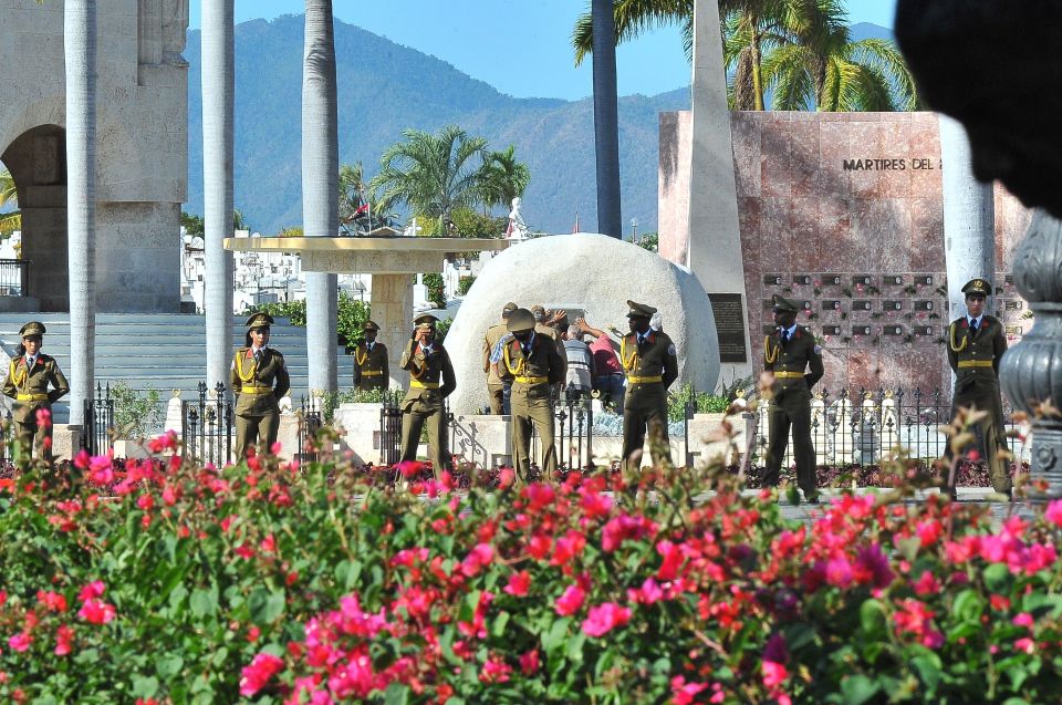  A guard of honour remains in place whilst workers fix the plaque with his name on Cuban leader Fidel Castro's tomb