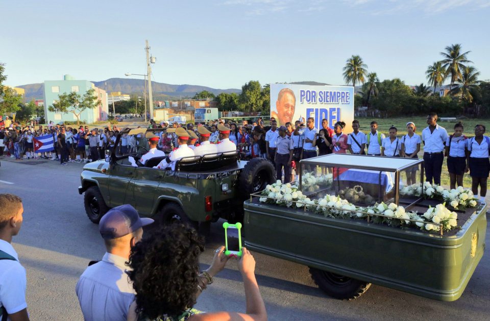  A military jeep pulls a trailer with the flag draped chest containing the remains of the revolutionary leader