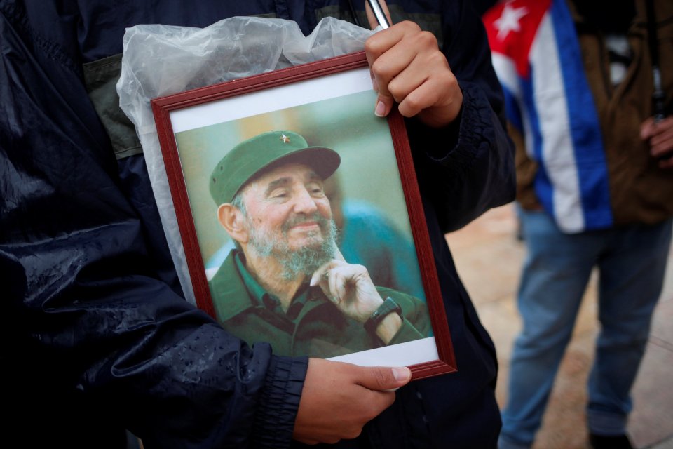  A supporter holds an image of former Cuban leader Fidel Castro at a tribute in Malaga