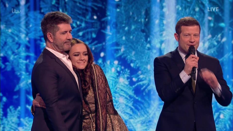  Emily was consoled by her mentor Simon Cowell, who she insists is not scary since having son Eric