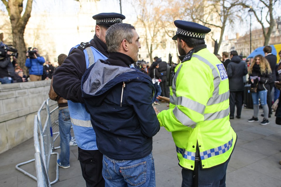 Police talk to protesting man