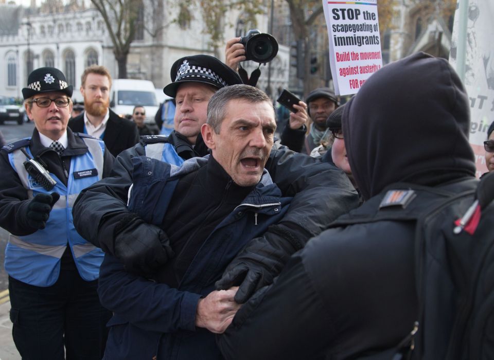 Officers hold man back