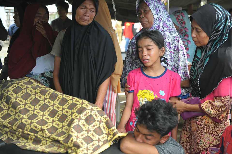  An Acehnese child cries for a relative killed in the chaos