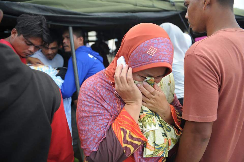  A woman grieves for her relative who died