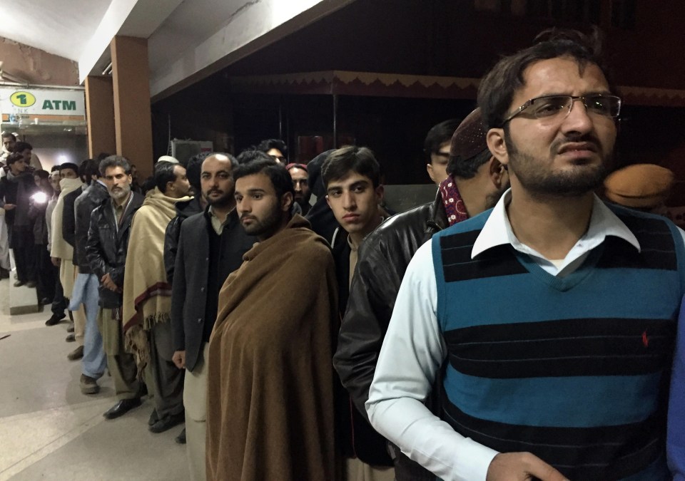  People gather outside the emergency ward, where authorities brought the remains of the victims