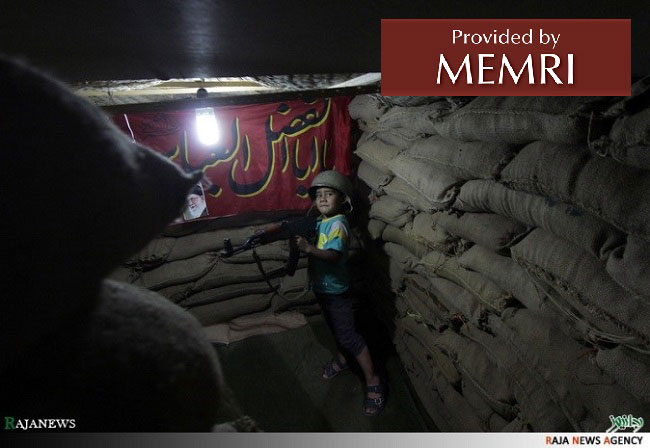  One boy at a sand-bagged check-point with replica assault rifle