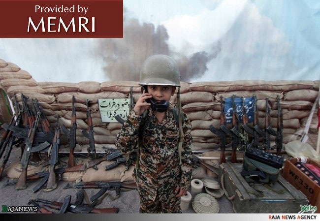  A young lad is surrounded by weapons in a makeshift bunker