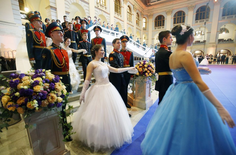  Photographs from the glamorous ball show the cadets making a grand entrance by walking down a staircase arm-in-arm with their partners