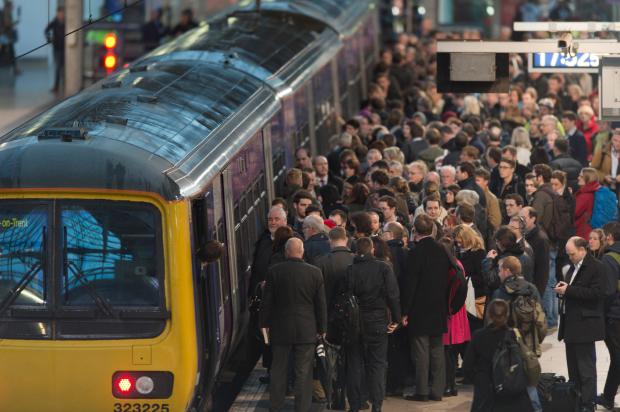 Manchester, UK. 21st October, 2014. The remnants of Hurricane Gonzalo caused considerable travel disruption to rail commuters across the United Kingdom, including those at Manchester Piccadilly. Some rail operators advised passengers to check servic