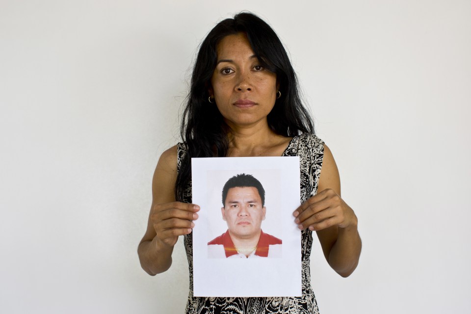  Adriana Bahena, who helped found the group The Other Disappeared, holds up a photo of her missing husband, Saulo Rodriguez Cruz