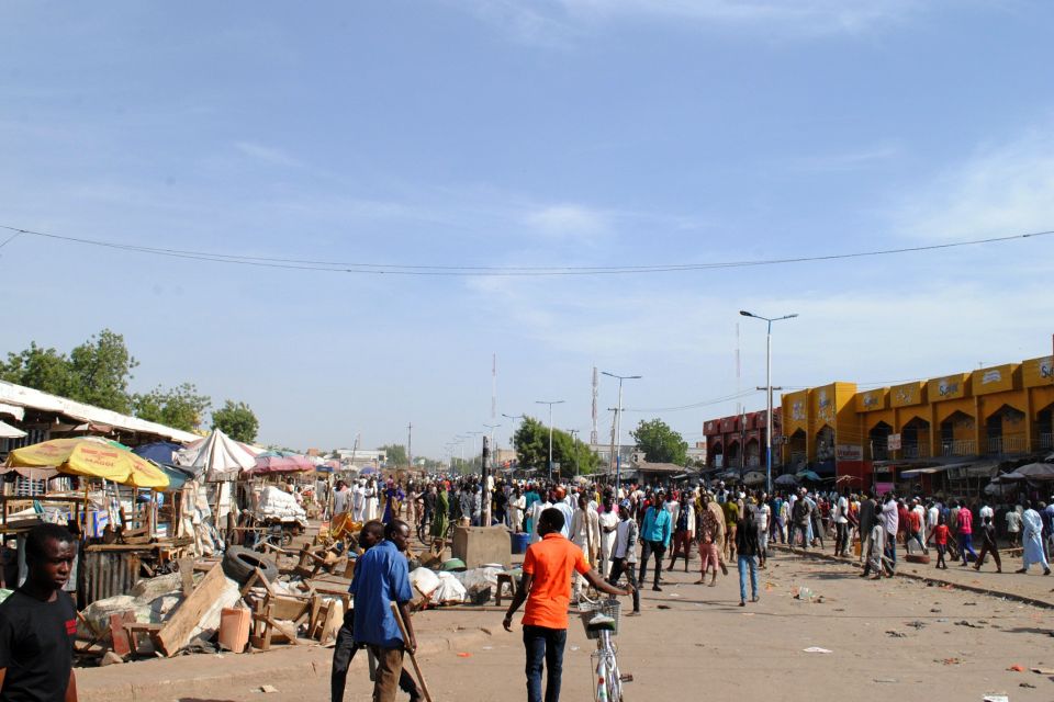 Residents gather near the scene of a sui