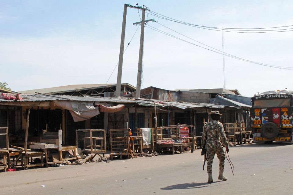 A soldier patrols near the scene of a su