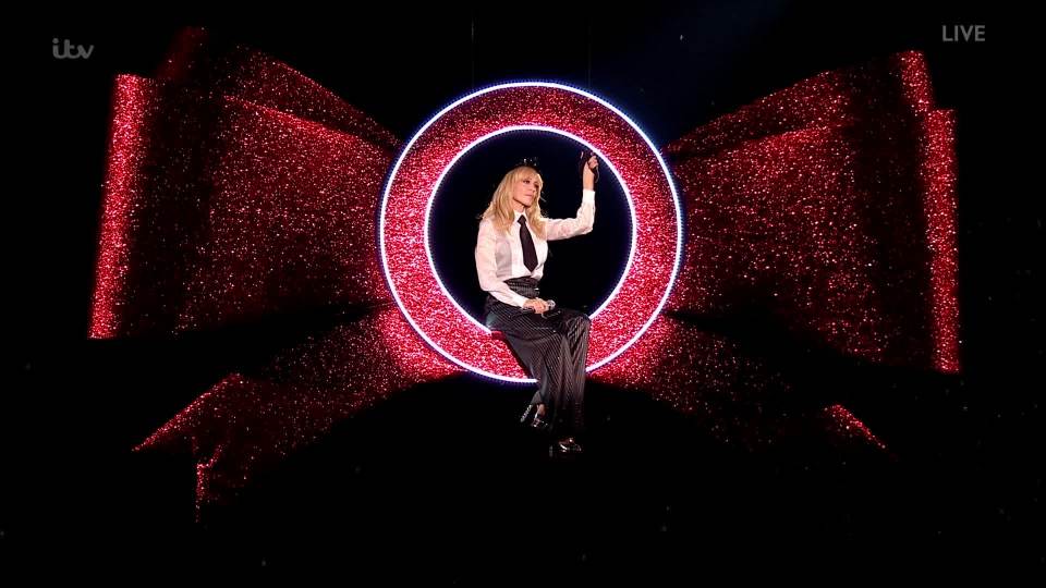  The giant bow floated across the audience before landing on the stage and depositing Kylie