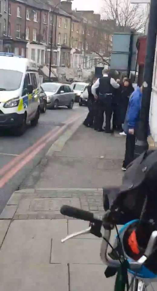  Police surround the man near the scene of the attack