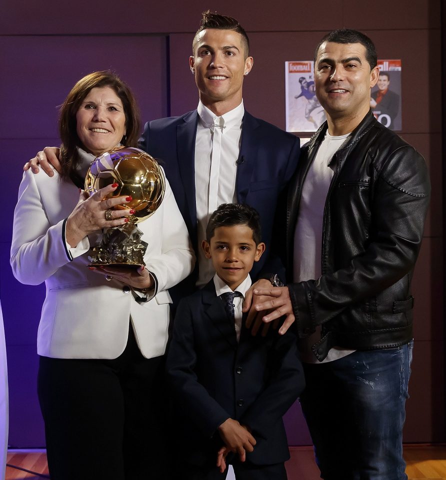  Cristiano Ronaldo gives his Ballon dOr award to mum Dolores to hold as he poses with son Cristiano Jr and brother Hugo