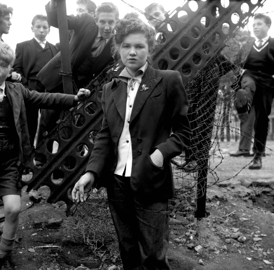  Film director Ken Russell captured teddy girls and boys in bombed-out London during the 1950s. Jean Rayner, 14, is seen posing in a smart two-piece suit on a derelict street