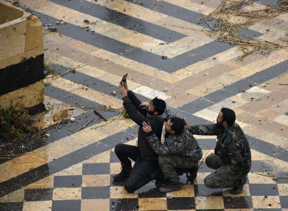  A group of blokes pose in the courtyard of the ancient Umayyad mosque in the old city of Aleppo - which has been left in ruins by the civil war