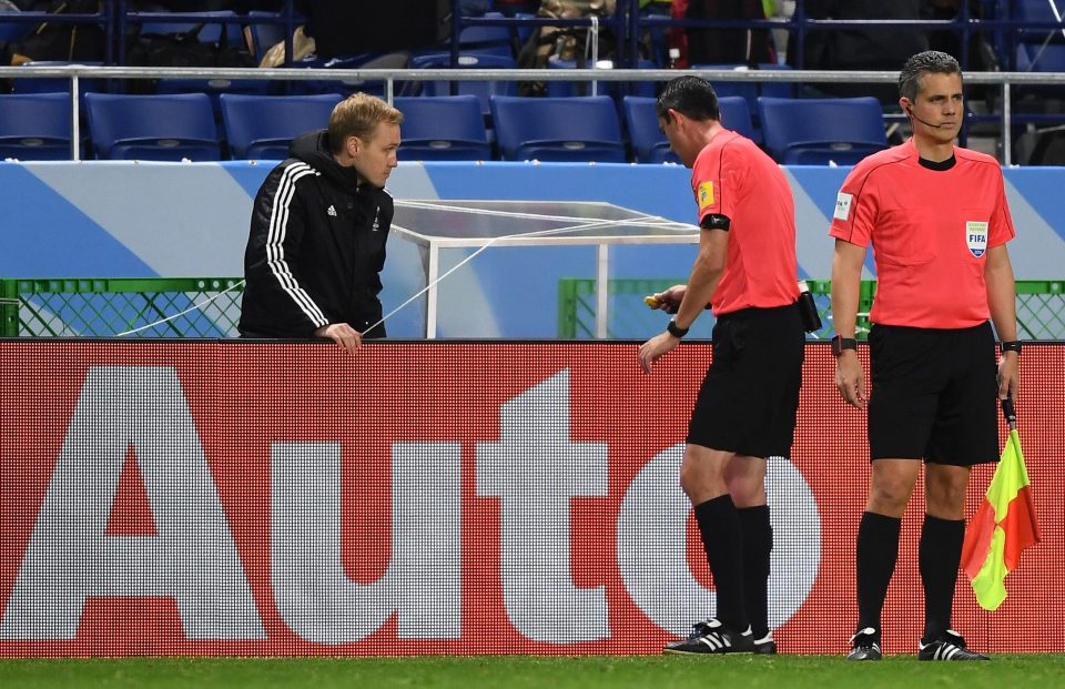  Viktor Kassai watches the instant replay of the penalty claim in the video booth