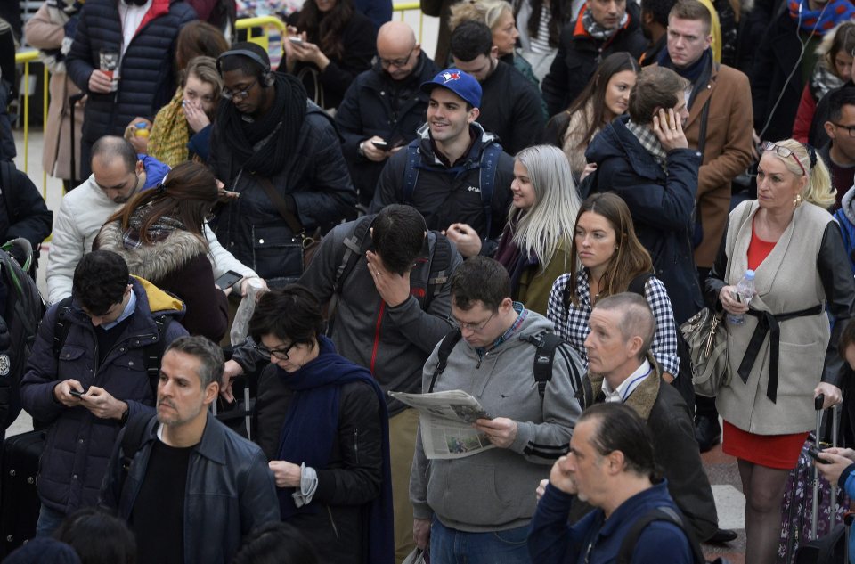  A passenger holds his face in his hand as he endures reduced services at London Victoria