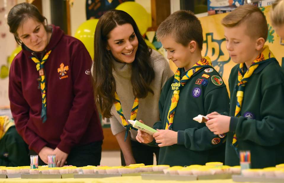  Kate donned the yellow and green traditional scarf while meeting youngsters