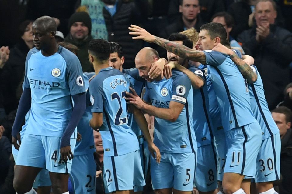  Pablo Zabaleta is mobbed by his Manchester City team-mates after scoring