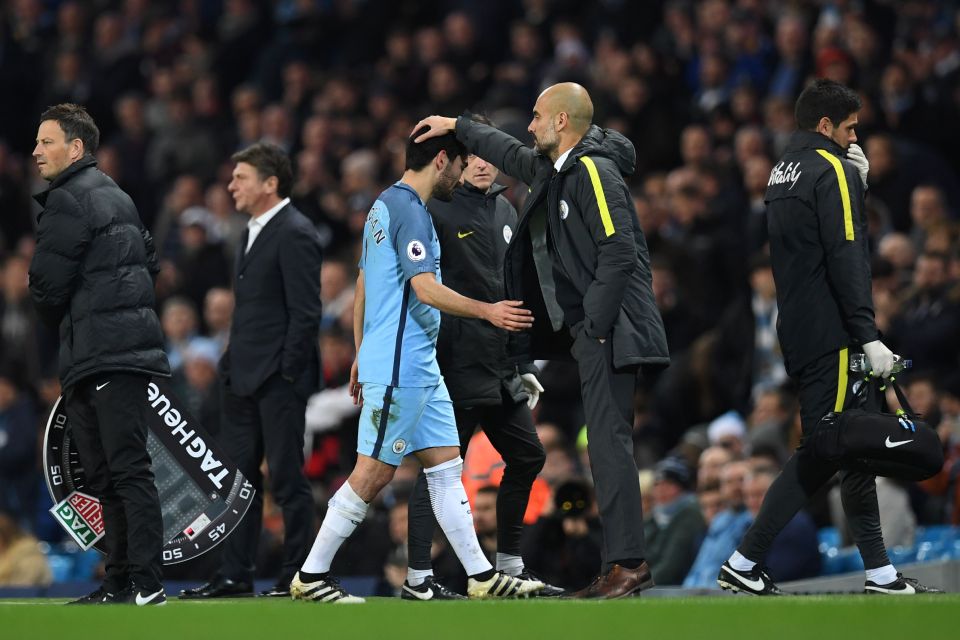  Distraught Ilkay Gundogan is greeted by boss Pep Guardiola as he leaves the pitch