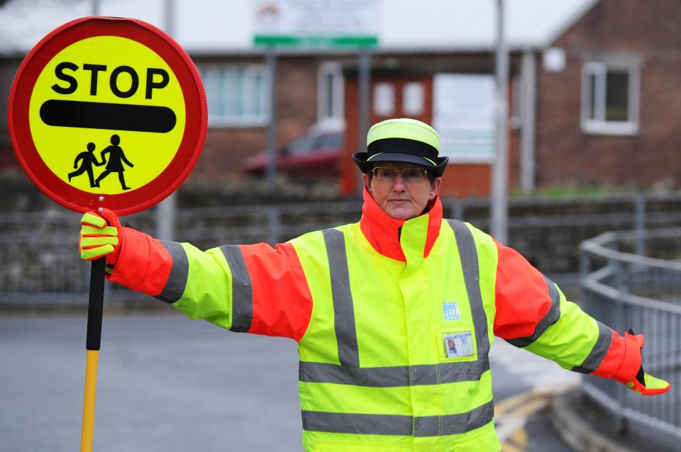  Jolly lollipop lady Sheila Allen has been banned by council bosses from greeting kids with a high-five after safety fears