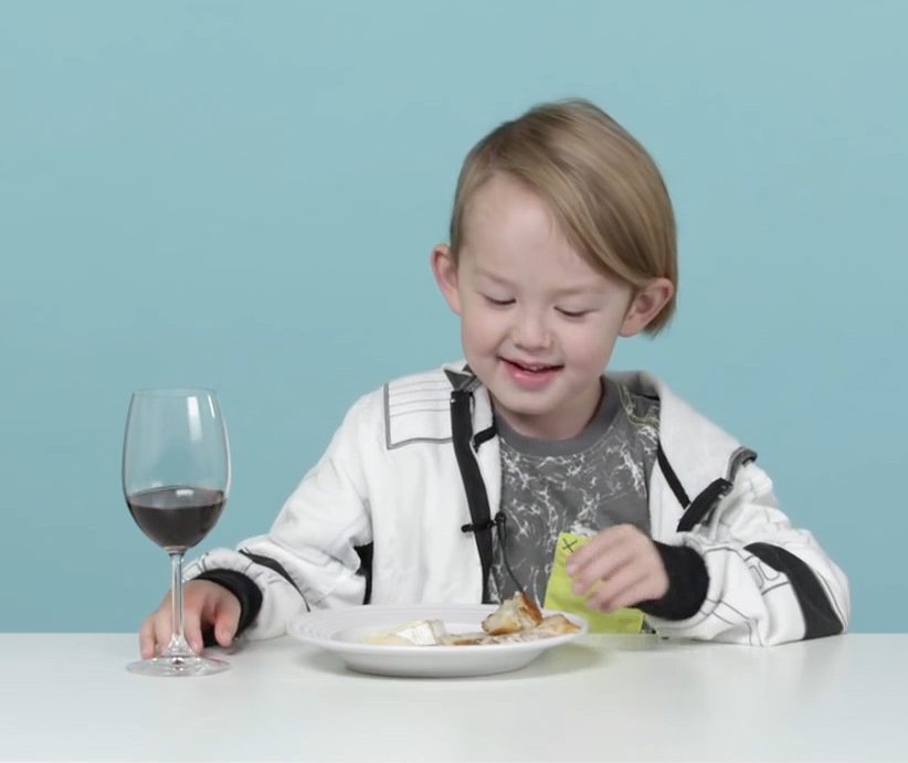 A young boy tries French cheese and red wine for the first time as part of an experiment 