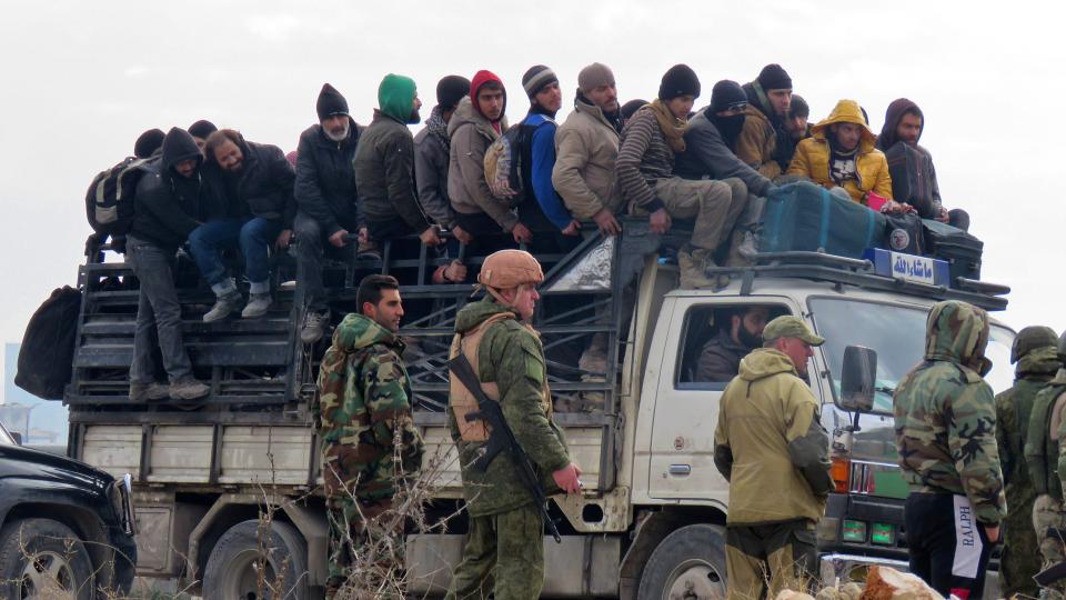 Ambulances drive in a convoy evacuating wounded civilians from the eastern part of Aleppo