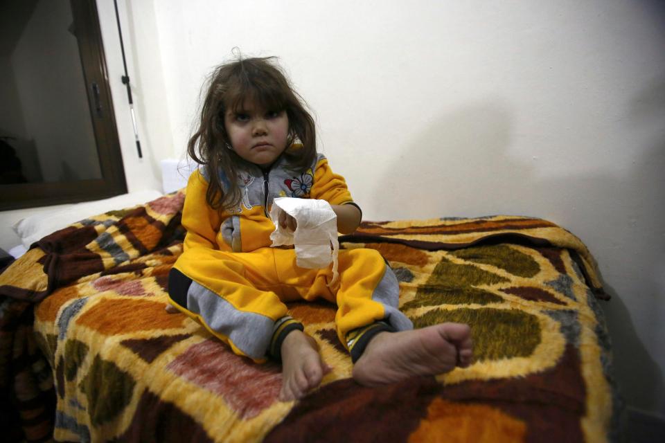  A Syrian child, evacuated from Aleppo, sits in a field hospital bed near Idlib, Syria