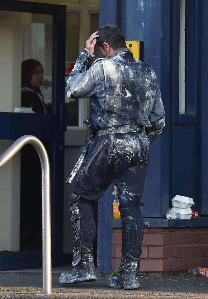  Officers were still seen in their paint-covered clothes outside the prison this morning