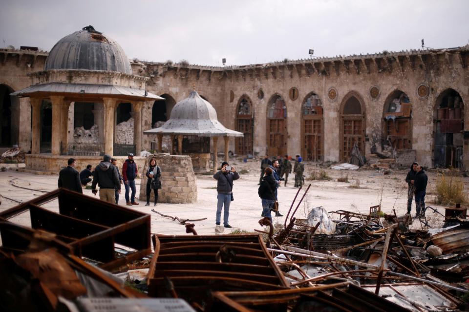  People visit the Umayyad mosque which has been destroyed during clashes in the northern city of Aleppo