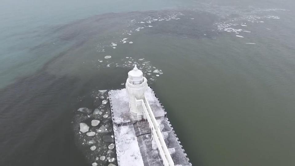 The image of the lighthouse spiralled with frozen fractals all around it set against the snow-white sky transformed the scene into an almost mystical vista