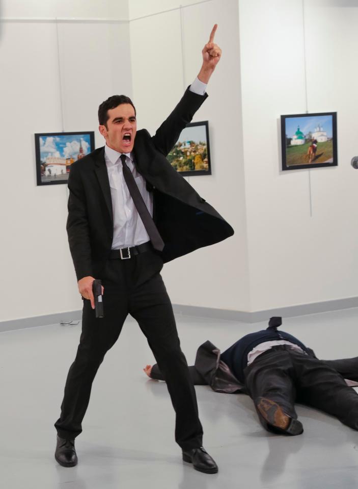  Gunman Mevlüt Mert Altintas gestures to Andrei Karlov, the Russian Ambassador to Turkey, after shooting him at a public event