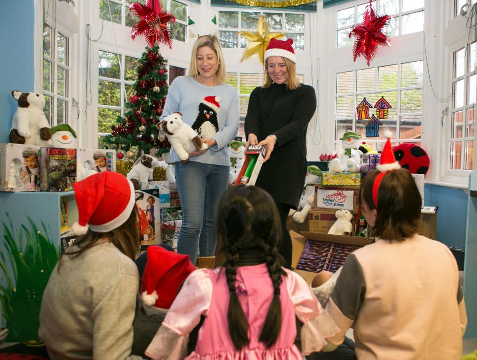  Refuge manager Charlotte Kneer (left) with The Sun's Sam Carlisle handing out gifts to kids