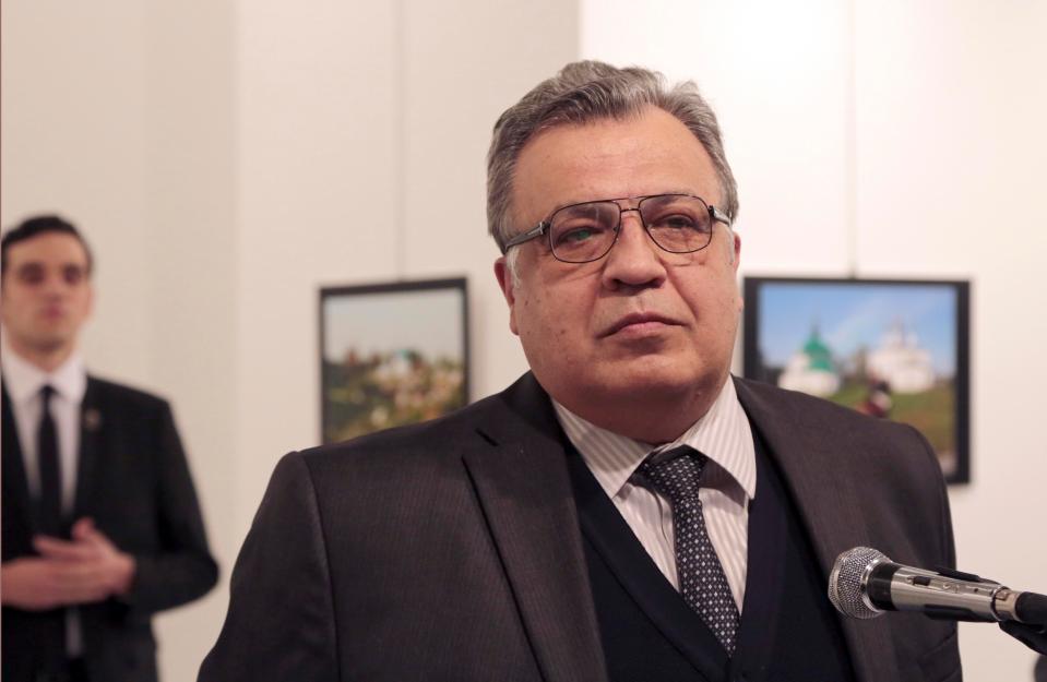  The killer was pictured behind the Russian Ambassador to Turkey Andrei Karlov before he shot him