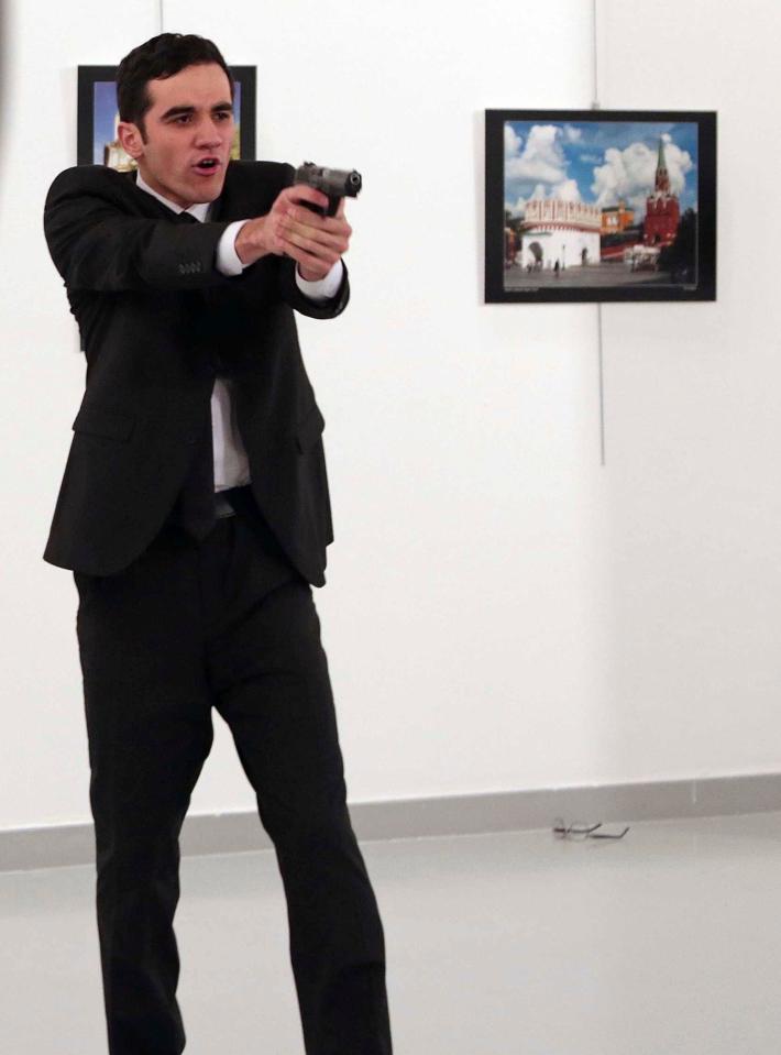  Altintas brandishes his pistol after shooting down the ambassador