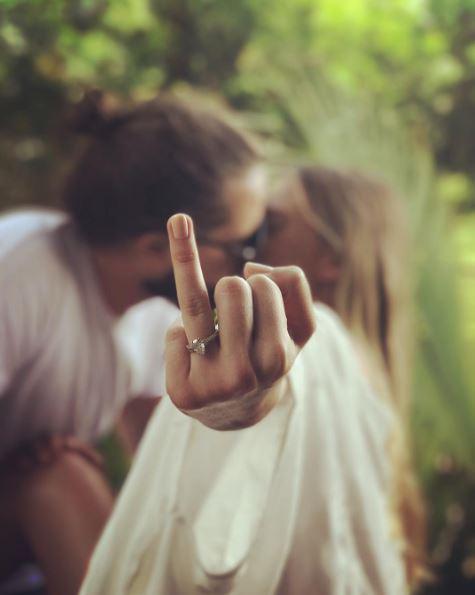  Margot Robbie shared this snap of her flashing her wedding ring while kissing new husband Tom