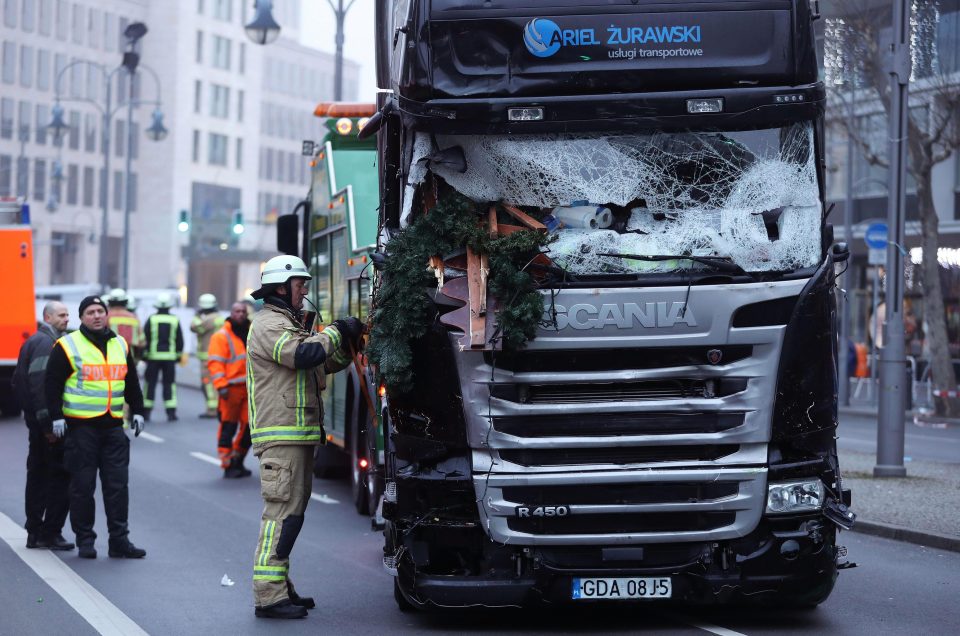  Debris and festive items are seen here lodged in the windscreen of the lorry after it was driven at speed through the market