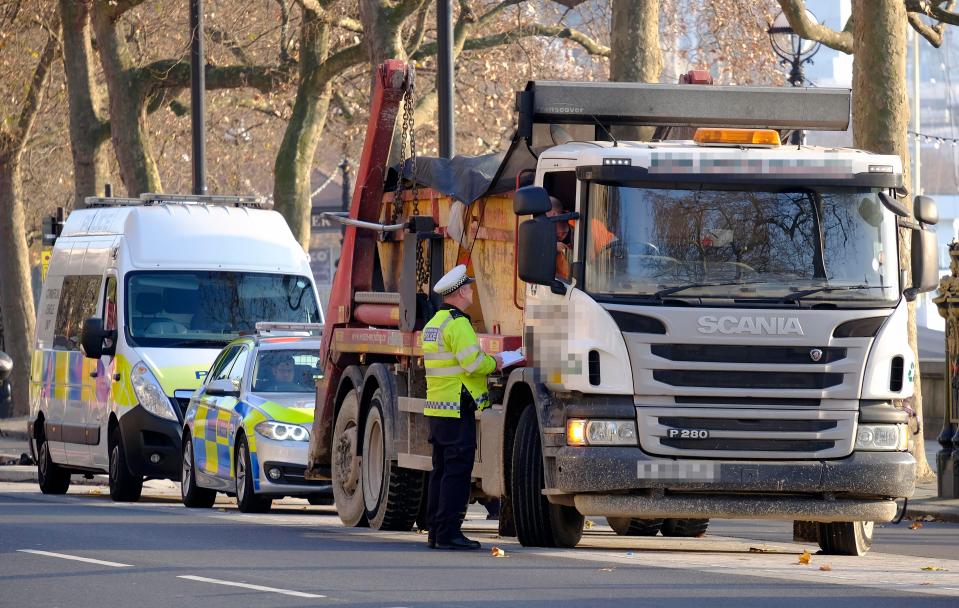  Met Police officers check a vehicle in London after a lorry ploughed into Christmas shoppers in Berlin