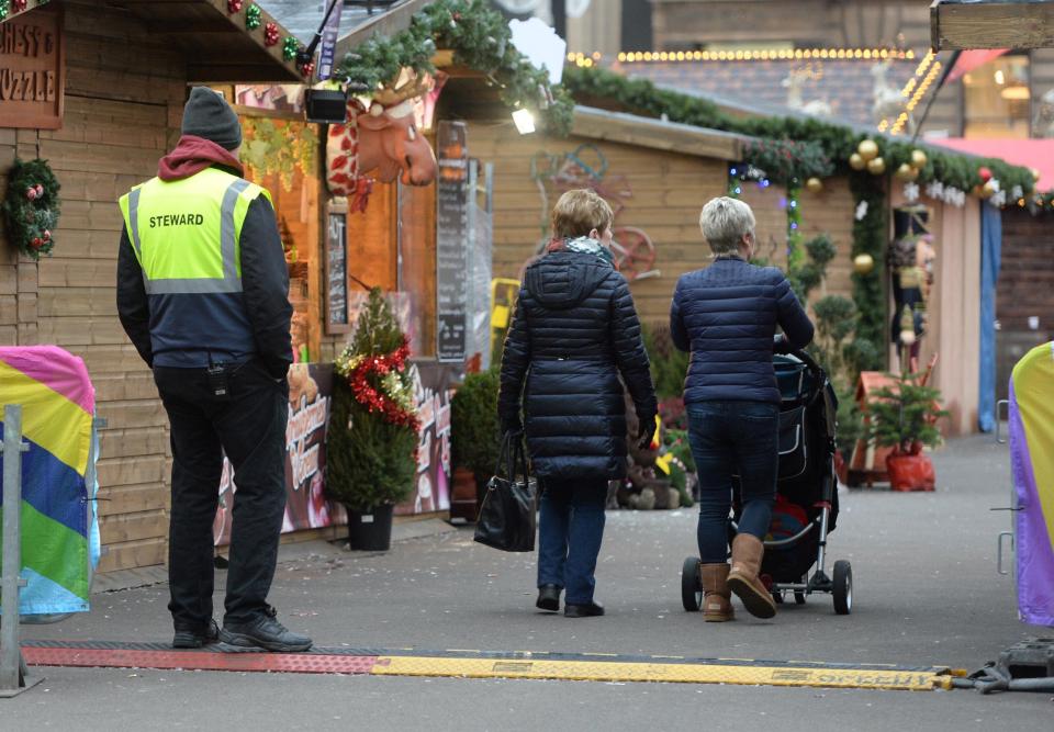  A steward at a Christmas market in Glasgow looks on this morning as security measures are increased across the UK