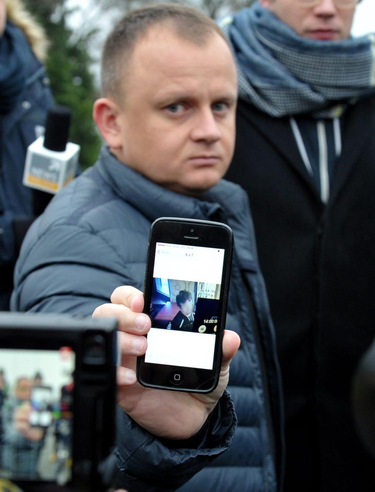  Ariel Zurawski shows a picture of his cousin Lukasz, who fought for his life after being stabbed but was shot by the jihadist