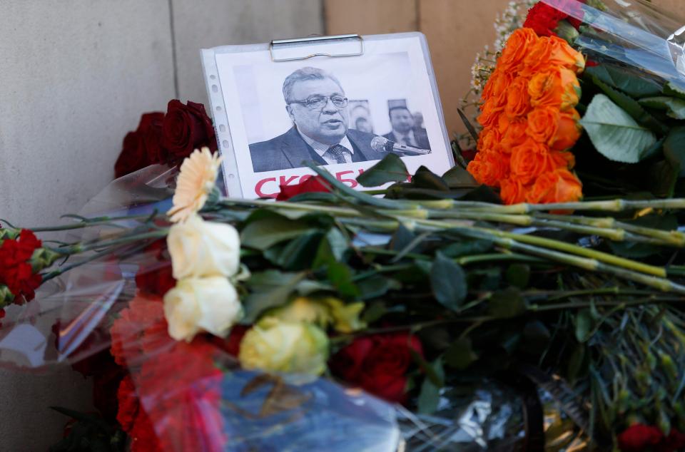  Flower tributes were left with a picture Russia's ambassador to Turkey Andrei Karlov outside the Russian foreign ministry in Moscow, Russia