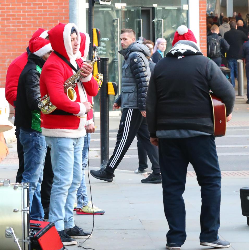  Shoppers and buskers don't seem to have noticed the Manchester United star