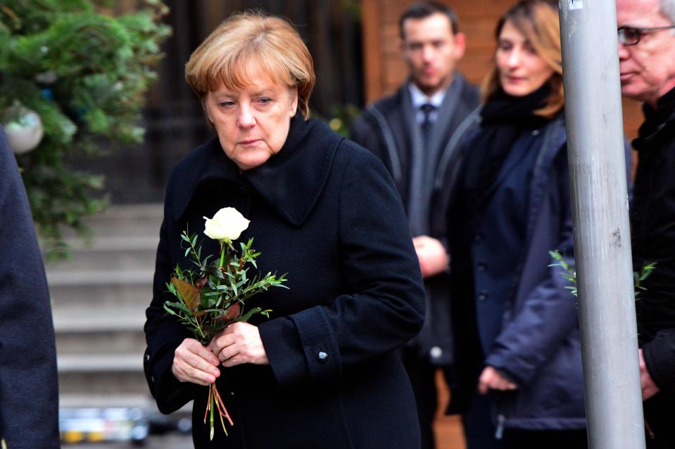  Raw . . . Angela Merkel pays her respects to the dead and injured in Berlin