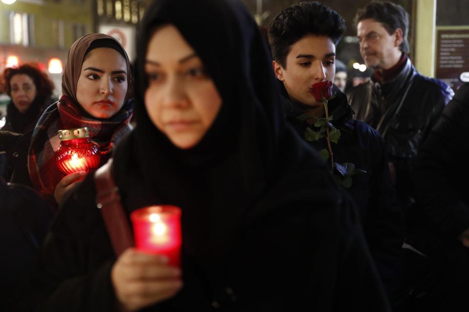  Locals bring lit candles to the scene of the tragedy