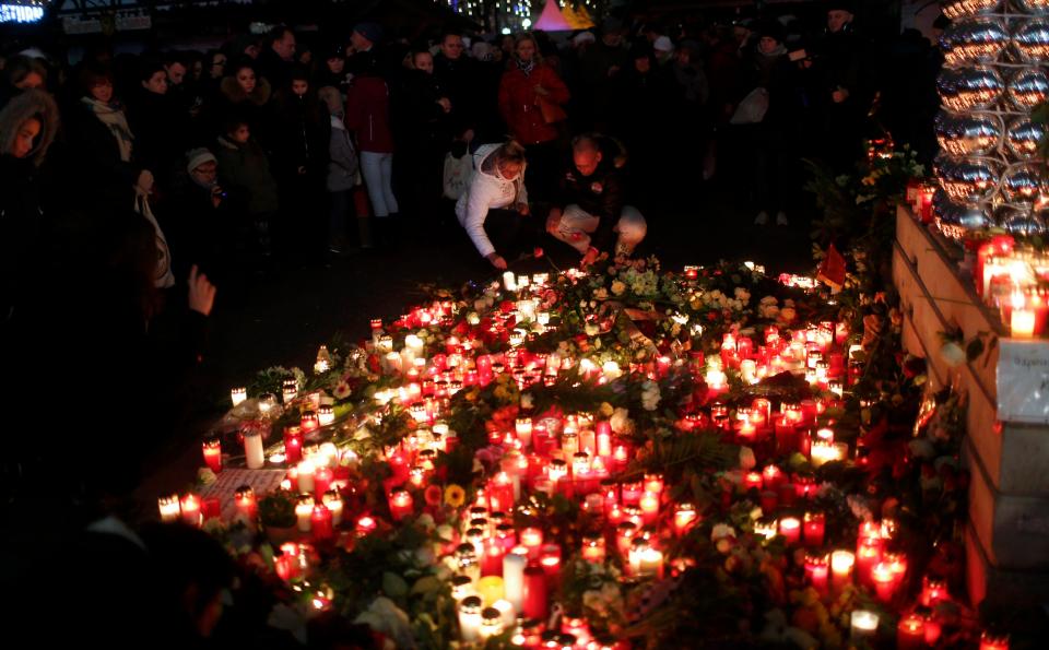  Candles and remembrance notes are placed by bystanders in Berlin