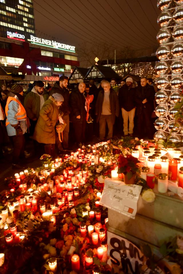 Mourners gather at the scene to pay tribute to those who lost their lives