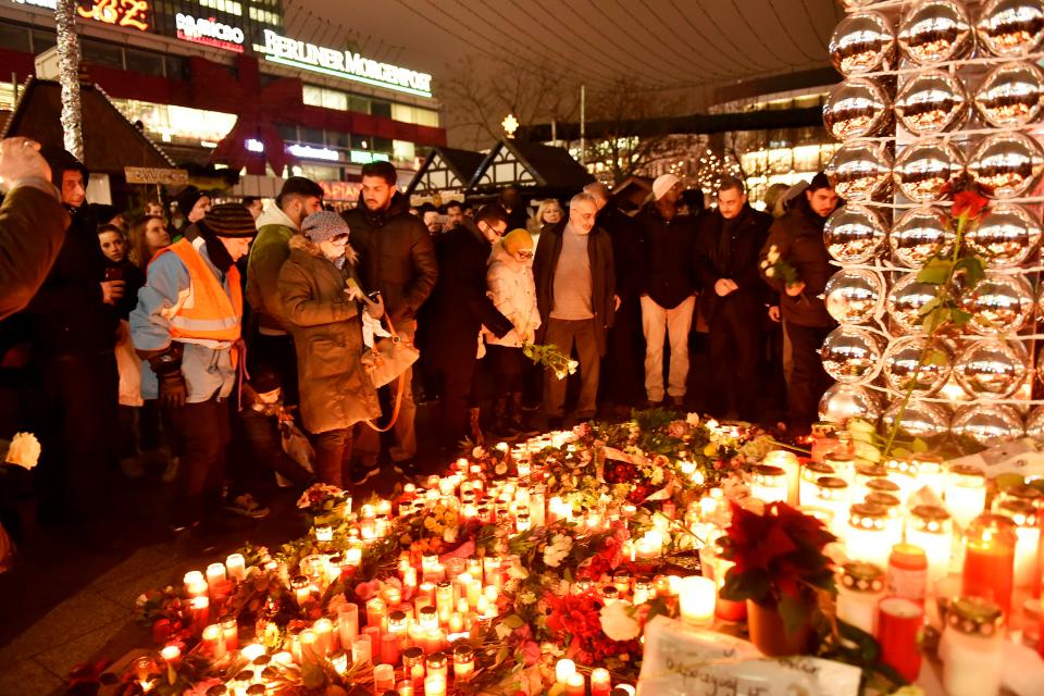  Devastated Germans set up vigils around the country overnight as details emerged that the terrorist behind the attack is still on the loose