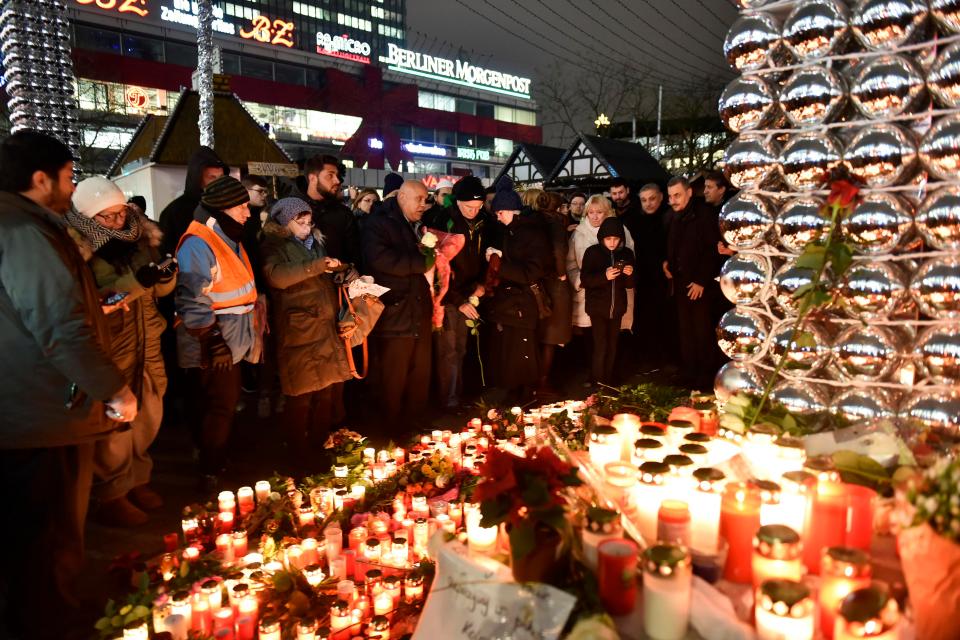  Locals hold a candlelit vigil for those who lost their lives